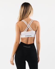 HIGHLIGHTS. Custom fabric blend made from our fine Italian yarn. Top finish treatments to achieve buttery softness. Unique filament count - allows extreme stretch and wicking capabilities. Scoop neckline. Medium support. ForeverKnit logo on waistband FIT SUGGESTION. This item runs true to Alphalete’s standard seamless fit.. If you are between sizes, we recommend sizing up.. Model is 5’8”/172cm, wearing a size XS with a 31”/78cm bust. MATERIALS AND WASHING DIRECTIONS. 51% Polyamide, 38% Polyester White High Stretch Seamless Sports Bra, White Seamless Supportive Activewear, White High Stretch Elastane Sports Bra, Supportive White Seamless Activewear, Supportive White Seamless Sports Bra, White Medium Support Activewear In Elastane, White Sporty Sports Bra With Seamless Design, White Activewear With Medium Support, Sporty White Sports Bra With Seamless Design