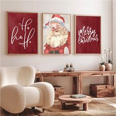 two christmas paintings hang on the wall in a living room with a chair and coffee table