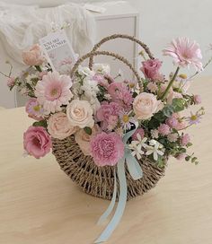 a basket filled with flowers on top of a wooden table