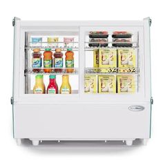 a refrigerated display case with drinks and condiments on the doors