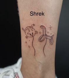 a woman's foot with a small tattoo on the ankle that reads shrek