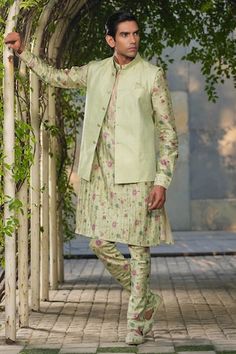 Mint green sleeveless Nehru jacket with stitchline thread embroidery in stripe pattern. Paired with floral print pleated kurta and churidar. - Aza Fashions Green Fitted Kurta With Stand Collar, Festive Green Nehru Jacket With Stand Collar, Fitted Green Bandhgala For Spring, Spring Green Fitted Bandhgala, Fitted Green Nehru Jacket For Spring, Green Fitted Nehru Jacket For Spring, Festive Green Outerwear With Stand Collar, Green Sleeveless Fitted Nehru Jacket, Kurta Set Men