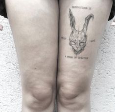 a woman's legs with tattoos on them and an image of a rabbit head