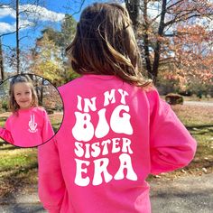 "This cozy crewneck is the perfect gift for a big sister (to be)! Featuring the saying \"In my big sister era\" in bold letters on the back, and their name on the front, this shirt is stylish and cute all year wear. For the Comfort Colors tshirt: https://sweetteezllc.etsy.com/listing/1479876676 𝐇𝐎𝐖 𝐓𝐎 𝐎𝐑𝐃𝐄𝐑 1. Select the size & color when applicable 2. Add the personalization (name, design etc) when required 3. Add to Cart & submit your order. 4. If ordered over $35, we have FREE shipping for you! 𝐀𝐋𝐖𝐀𝐘𝐒 𝐇𝐀𝐍𝐃𝐌𝐀𝐃𝐄 * Each item is handmade and made to order here in Florida! * We carry several different brands and use different brands for different listings, including Rabbit Skins®, Gildan®, Gerber Onesie®, Bella Canvas® and Comfort Colors®. G A R M E N T ∙ F E A T U R Personalized Pink Crew Neck Sweater, Cute Long Sleeve Tops With Funny Text, Big Sister To Be, Bold Letters, Comfort Colors Tshirt, Pregnancy Announcement Shirt, Big Sis, Pink Crewneck, Raglan Shirts