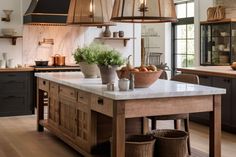 a large kitchen island with lots of counter space and lights hanging from it's ceiling