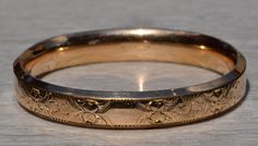 Signed Austin & Stone Gold Filled Floral Engraved Bangle Bracelet.  The bangle measures 7.5 inches in size  and features original floral engraving throughout.  The bracelet is signed Austin & Stone on the inside and is in great condition. Love this piece, but don't have the money to spend right now?  We offer FREE layaway on every item in our shop.  With just 20% down, take one full year (interest-free) to pay off your new jewelry!  There are no hidden fees or charges, ever.  For more informatio Classic Formal Bracelets With Decorative Band, Heirloom Cuff Bracelet With Intricate Design For Formal Occasions, Classic Bracelets With Decorative Band For Formal Occasions, Formal Cuff Bracelet With Intricate Design, Vintage Etched Yellow Gold Bangle, Classic Etched Bangle Jewelry, Vintage Etched Yellow Gold Bracelets, Classic Etched Bangle Bracelet, Classic Etched Bangle Bracelets