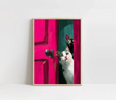 a white and black cat looking out from behind a pink door with two green eyes