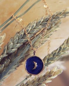 A sweet blue & gold moon pendant hangs from a soft gold chain. Color: Gold & blue Length: 18"-20" total Pendant width: 1" Blue Sun And Moon Pendant Necklace, Blue Celestial Necklaces With Sun And Moon Design, Blue Necklace With Sun And Moon Design For Gift, Blue Gold-plated Charm Necklace With Adjustable Chain, Blue Sun And Moon Necklace For Gift, Blue Sun And Moon Design Necklace For Gift, Blue Moon Charm Necklaces For Gifts, Handmade Blue Moon-shaped Necklaces, Blue Moon Charm Necklace For Gift