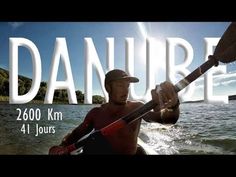 a man holding onto a large fish on top of a body of water with the words'danurre'in front of him