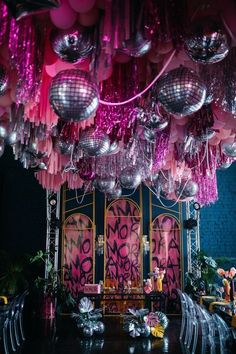 a room filled with lots of shiny disco balls and chandeliers hanging from the ceiling