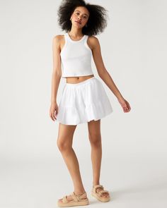 The AISHA skirt is a tiered bubble mini skirt, perfect for any fashion-forward individual. Its unique design adds volume and texture to your look. Make a statement with this one-of-a-kind skirt. Mini tiered bubble hem skirt Functional side pockets 100% cotton Hand wash Nina is 5ft 10in and is wearing a size small Imported Trendy Flowy Tiered Skort, Trendy Relaxed Tiered Skort, Spring Mini Skort, Casual Flared Cargo Skirt For Summer, Cotton Flared Skort With Ruffled Skirt, Trendy Tiered Gathered Skirt, Casual Voluminous Skirt Skort For Spring, Tiered Gathered Mini Skirt For Summer, Trendy Gathered Tiered Skirt