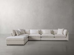 a large white couch sitting on top of a floor