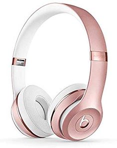 the beats by dr dre headphones are in rose gold and white color scheme