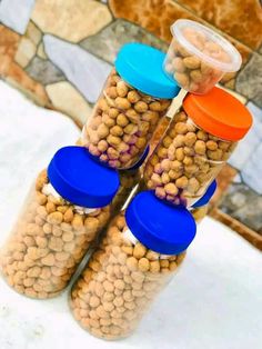 three jars filled with food sitting on top of a table