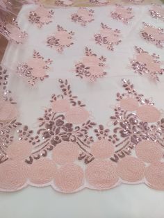 pink and silver sequin lace on white fabric