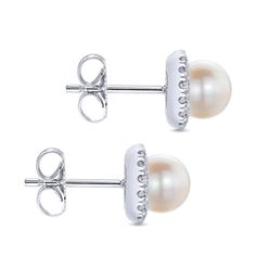 Designer Gabriel's masterfully crafted pearl stud earrings feature luminous round pearls accented by shimmering 0.22 carat diamond halos for a sophisticated and timeless addition to any jewelry collection. Elevate your style with these must-have earrings. Available in 14K or 18K white, rose or yellow gold Includes earring box Includes jewelry appraisal Ships fully insured to point of delivery Formal White Brilliant Cut Earrings, White Cluster Earrings For Formal Occasions, Elegant White Round Cluster Earrings, White Round Cluster Earrings For Formal Occasions, Classic White Earrings With Diamond Accents, Luxury White Cluster Earrings With Halo Design, Elegant White Cluster Earrings With Halo Design, Luxury White Cluster Earrings For Anniversary, Luxury White Cluster Earrings With Diamond Accents