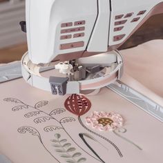 the sewing machine is being used to sew flowers