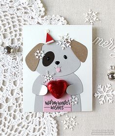 a card with a dog holding a heart on it's side and snowflakes around the edges