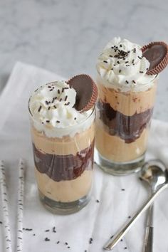 two desserts with whipped cream and chocolate on top