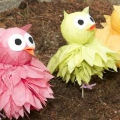 three paper birds are sitting in the dirt