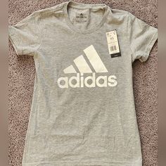 Women's Adidas T-Shirt Size M Affordable Adidas Logo Athleisure T-shirt, Cheap Adidas Tops With Logo Print, Gray Logo Print T-shirt For Spring, Basic Adidas T-shirt With Graphic Print, Adidas Gray Cotton Tops, Adidas Tops With Logo Print For Spring, Adidas Logo Print T-shirt For Spring, Adidas Spring T-shirt With Logo Print, Basic Adidas Tops With Logo Print