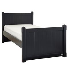 a black bed frame with white sheets on it and no headboard or foot board