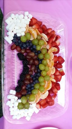 grapes, strawberries, oranges and other fruits arranged in the shape of the number seven