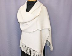 "This luxurious hand woven alpaca shawl is the perfect accessory for any season.  It is soft, but warm enough for a cool spring evening or for cuddle by a winter fire.  This elegant piece would make a wonderful wedding wrap.  It measures a generous 84\" long by 17.5\" wide, enough to wrap you in snuggly softness.  Hand wash in gentle soap and dry flat.  A warm iron may be used." Elegant Alpaca Shawl, Elegant White Poncho For Winter, Elegant White Winter Poncho, Handwoven Alpaca Shawl, Elegant Alpaca Shawl Scarf, White Shawl Wrap Scarf, White One-size Wrap, White One Size Wrap, One Size White Wrap