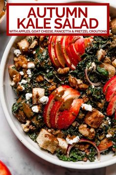 a white bowl filled with kale salad topped with apples and goat cheese covered in pecans