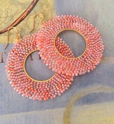 Handmade Bright Seed Bead Hoop Earrings Spring and Summer Jewelry Hoop earrings made with a blend of coral satin and Aurora borealis finish seed beads. The french hook earwires and findings are 14kt gold plated. These very lightweight earrings measure 3 inches total. The hoops are 1.5 inches. Absolutely perfect for warm weather outfits.  Great for daywear and stunningly chic for the night out.  Thank you for looking and please stop by again soon. Brick Stitch Earrings, Bead Work Jewelry, Message Jewelry, Colorful Earrings, Beaded Hoop Earrings, Beaded Hoops, Design Jewelry, Seed Bead Earrings, Brick Stitch