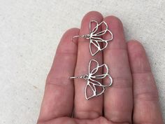 "These are unique, funky and whimsical silver flower earrings! They have such a fun and playful vibe with their modern design style. They are lightweight and comfortable. The perfect everyday earring, versatile and stylish. The earrings measure 5/8\" long by 1\" wide and hang from simple silver ear wire hooks. Overall drop length is 3/4\". Made from allergy free plated rhodium and silver. I have a matching necklace in my shop, if you would like the whole set. Here is the link Thanks for stopping Nickel-free Silver Flower Earrings For Spring, Spring Flower Earrings In Silver, Nickel-free, Whimsical Silver Hypoallergenic Earrings, Spring Silver Flower Earrings Nickel Free, Spring Sterling Silver Earrings With Flower Charm, Spring Nickel-free Silver Earrings, Sterling Silver Drop Earrings For Spring, Dainty Silver Earrings For Spring, Silver Flower Earrings For Spring Gift