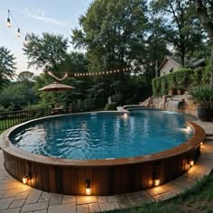 an above ground pool with lights around it