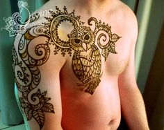 a man with an owl tattoo on his chest