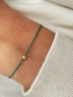 This silk string bracelet is made from silk cord and solid 14K gold, sterling silver, or  24K gold vermeil  3 mm bead. Wish bracelet is a beautiful way to give someone you care for a wish. All they have to do is make a wish and then tie the cord around their wrist. When the cord finally wears down and breaks the wish is released and will come true - so they say! Details:  * 14K solid gold, sterling silver or 24K gold vermeil bead - 3 mm; Silk String * Adjustable clasp stainless steal silver or g Adjustable Yellow Gold Bracelets, Gold Jewelry With Adjustable Cord For Good Luck, Dainty Yellow Gold Jewelry With Sliding Knot, String Of Fate, Bracelet String, Bracelet Evil Eye, Stainless Steal, Gold Silk, Silk Cord