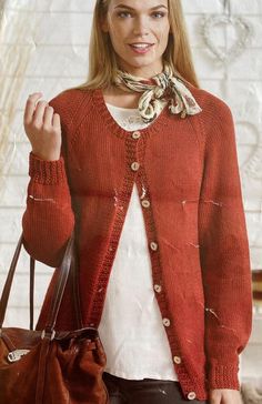 a woman holding a brown purse and wearing a red cardigan