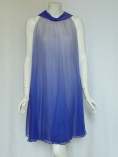 "Exquisite & Rare!!  FLORILEGE BALMAIN Vintage late 50s/early 60s Silk Georgette Ombré Chiffon Trapeze Dress!! This luxe vintage frock is styled with a loosely gathered trapeze silhouette from the neck, with a modified scarf cowl neckline in royal cerulean blue that sends diaphanous ombré flyaway neck ties down the back; tie them, loop them or just let them drape freely! There is a sheath underdress that is also covered in a layer of the ombre silk chiffon. The delicately textured silk chiffon t Blue Sheer Silk Dress, Blue Chiffon Evening Dress For Summer, Blue Sleeveless Silk Chiffon Dress, Summer Sheer Silk Chiffon Dress, Blue Silk Chiffon Evening Dress, Blue Silk Chiffon Summer Dress, Blue Silk Chiffon Dress, Blue Vintage Chiffon Dress, Blue Chiffon Cocktail Dress