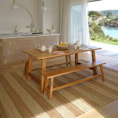 a wooden table sitting in front of a window