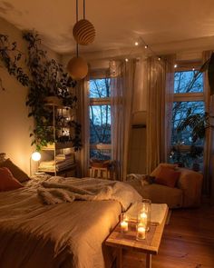 a bed room with a neatly made bed and candles