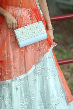 With this Chandni Flap Bag, your ensemble looks beautiful. This clutch will surely catch everyone's attention. The zardozi embroidery is a handicraft and textile signature of Lucknow, Hyderabad, Farrukhabad & Chennai. Zardosi is an art that uses metallic coated thread to make beautiful, intricate designs on cloth. To make these elaborate designs, the thread is held with a finger at the reverse of the fabric and the aari, a needle with a sharp point, is held on the top. Craftsmen use materials li Luxury Rectangular Clutch With Pearl Embellishments, White Rectangular Clutch With Pearl Embroidery, Luxury Rectangular Clutch With Pearl Embroidery, Embroidered Silver Rectangular Clutch, Elegant Rectangular Clutch With Intricate Embroidery, Elegant Clutch, Gala Gown, Zardozi Embroidery, Thanksgiving Sale