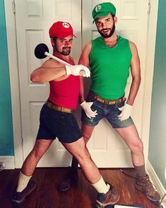 two men dressed up as mario and luigi from mario kartman, standing in front of a doorway