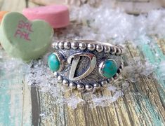 To order: Select your size (please know your size these can not be resized) Add either your initial in the personalize box or upload your brand Place your order. This turquoise brand ring features 2 Kingman turquoise with a floral design and beaded board. Add your brand or initial to customize this ring for a unique cowboy or cowgirl design. Make it your own with your special symbol in the center. Give as a gift or treat yourself. Makes the perfect simple class ring as well with your year or log Sterling Silver Stamped Turquoise Ring Gift, Gift Turquoise Sterling Silver Ring, Stamped Turquoise Rings For Gifts, Cowgirl Design, Western Rings, Turquoise Branding, Bracelet Size Chart, Special Symbols, Kingman Turquoise