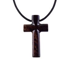 a wooden cross on a black cord necklace