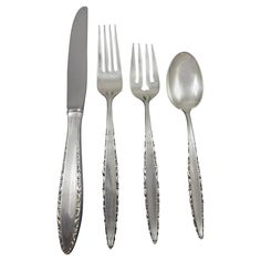 an assortment of silverware including forks, knives and spoons on a white background