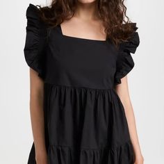 A Refreshing Take On A Versatile Mini. This English Factory Dress Is Crafted From Crisp Cotton Poplin And Features A Tiered Skirt And Flutter Sleeves For A Romantic Version Of A Polished, Everyday Piece. Fabric: Mid-Weight, Non-Stretch Poplin Square Neckline And Flutter Sleeves Tiered Skirt And Ruffle Trim Hook-And-Eye And Hidden Zip At Back On-Seam Side Pockets Shell: 100% Cotton Lined Chic Cotton Ruffle Sleeve Dress, Cotton Mini Dress With Ruffles For Date Night, Black Ruffle Sleeve Dress For Summer, Chic Tiered Cotton Mini Dress, Chic Cotton Tiered Mini Dress, Black Flutter Sleeve Mini Dress For Spring, Black Mini Dress With Flutter Sleeves For Spring, Chic Black Mini Dress With Flutter Sleeves, Chic Tiered Mini Dress For Daywear