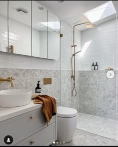 a bathroom with a sink, toilet and shower in the middle of it's walls