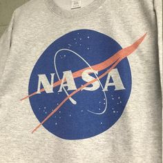 Nasa Meatball logo Heather ash gray Sweatshirt Heather Grey Cotton Sweatshirt With Logo Print, Gray Cotton Sweatshirt With Logo Print, Athletic Heather Cotton Sweatshirt With Graphic Print, Cotton Athletic Heather Sweatshirt With Graphic Print, Graphic Print Cotton Sweatshirt In Athletic Heather, Gray Cotton Pre-shrunk Sweatshirt, Gray Cotton Sweatshirt With Graphic Print, Gray Relaxed Fit Sweatshirt With Screen Print, Space Day