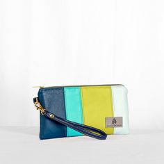 Made from reclaimed premium luxury leather alternative material , this wristlet showcases our signature brand colors! Designed and handcrafted by a woman in recovery on our team, your purchase creates possibilities for her to thrive in her sobriety. We hope you carry this wristlet with pride as a statement piece. This bag is wipe-clean! Disinfect with soap and water or hand sanitizer. With it’s detachable leather alternative strap, it can be carried as a regular wristlet, or remove the strap and Modern Wristlet With Wrist Strap For Everyday Use, Modern Everyday Wristlet With Wrist Strap, Modern Wristlet With Wrist Strap As Gift, Handmade Trendy Wristlet For Everyday Use, Trendy Handmade Wristlet For Everyday, Handmade Wristlet For Everyday, Trendy Green Wristlet For Everyday Use, Multicolor Wristlet For Everyday Use, Green Trendy Wristlet For Everyday Use