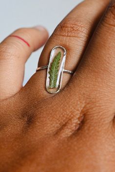 ✿description >m a d e to o r d e r < - .925 sterling silver ring - non-toxic+uv-resistant, BPA free resin. Safe for everyday wear - due to natural limitations, the ferns may vary from the ferns in the photo. this ring takes two weeks to create & ship. If you need expedited shipping please contact me before purchasing Mini Here: https://www.etsy.com/listing/983844411/silver-mini-fern-ring?ref=shop_home_active_3 More Rings Here: https://www.etsy.com/shop/mentalgardens/?section_id=2709362 Handmade Nature-inspired Flower Ring, Nature-inspired Rings With Natural Inclusions For Promise, Nature-inspired Promise Rings With Natural Inclusions, Nature-inspired Ring With Natural Inclusions, Nature-inspired Pressed Flower Ring Jewelry, Nature-inspired Silver Rings With Natural Inclusions, Fairytale Ring, Silver Fern, How To Clean Metal