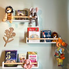 three shelves with books and stuffed animals on them