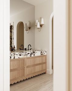 a large bathroom with two sinks and mirrors